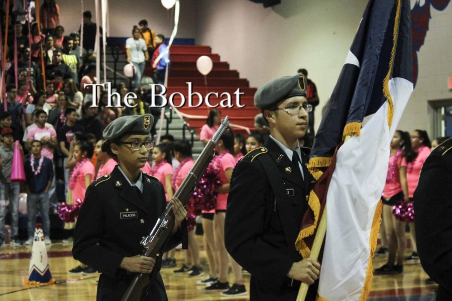 Junior, Benito Ibanez and freshman Cadet Hilda Palacios stand at attention during the singing of the national anthem.