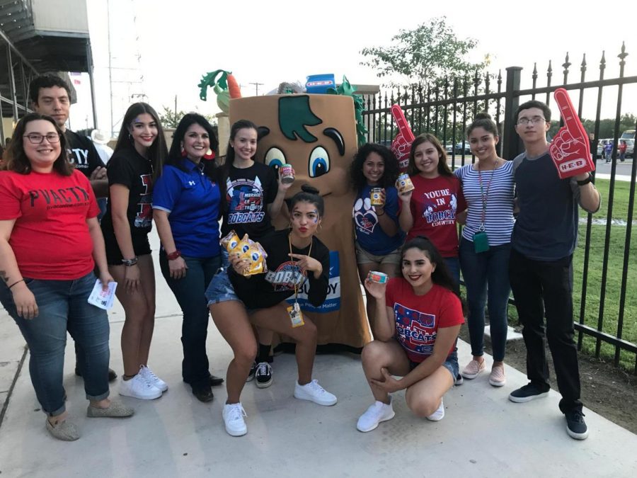 Student council members and Principal Molina, stand with HEB personnel as they donate the collected cans. 
