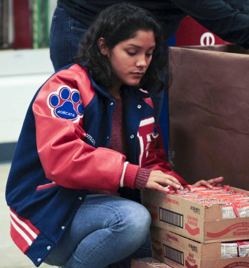 Student council member Samantha Garza organizes food donated for the drive.