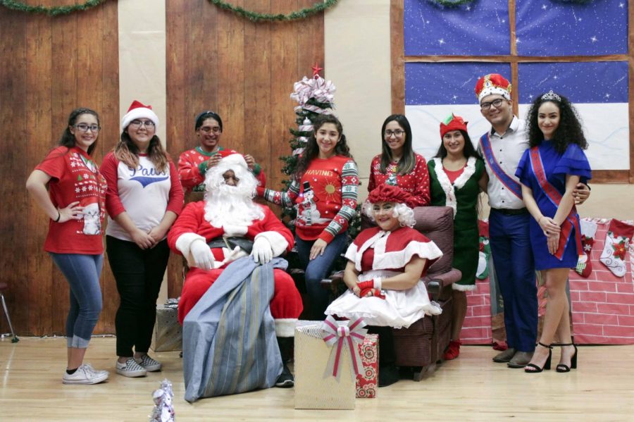 The Migrant Club officers stand with Santa and Mrs. Claus at  Adopt an Angel.