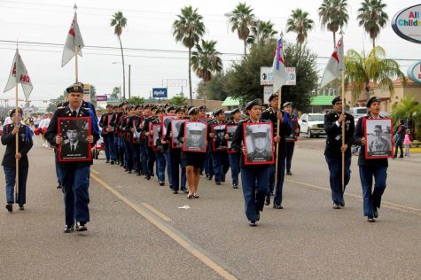 JROTC members participate in the Veterans Day parade while honoring alumni Veterans.