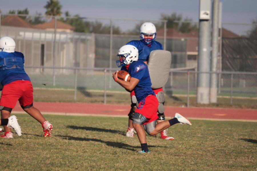 Senior Justin Gonzalez runs with the ball during practice.