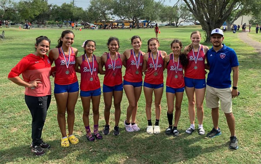 After+placing+at+the+District+Meet%2C+the+Varsity+Girls+Cross+Country+Team+stands++with+Coach+Torre-Salinas+and+Coach+Serrano.